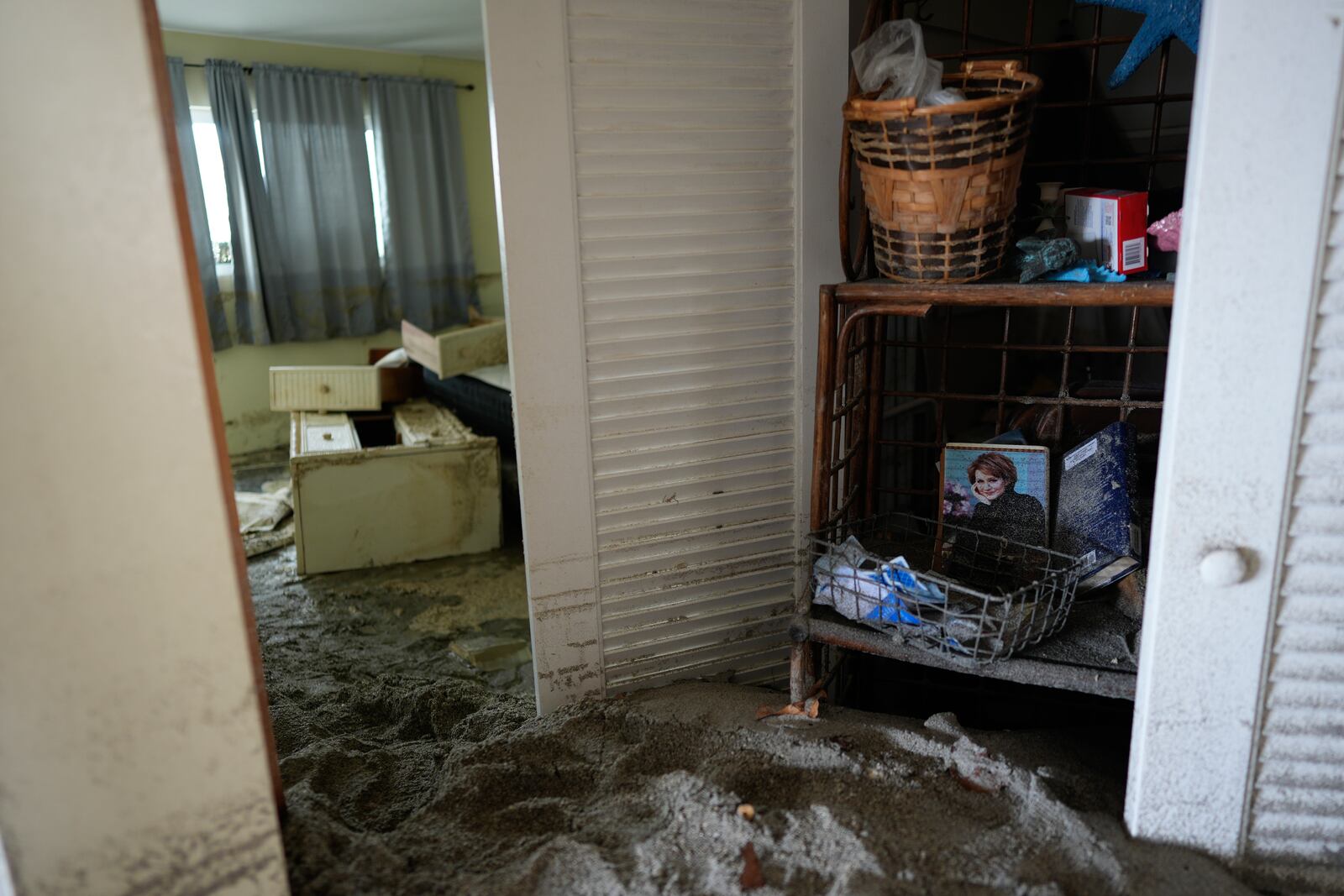 Several feet of sand fills a condo following the passage of Hurricane Milton at YCA Vacation Rental in Venice, Fla., Friday, Oct. 11, 2024. (AP Photo/Rebecca Blackwell)