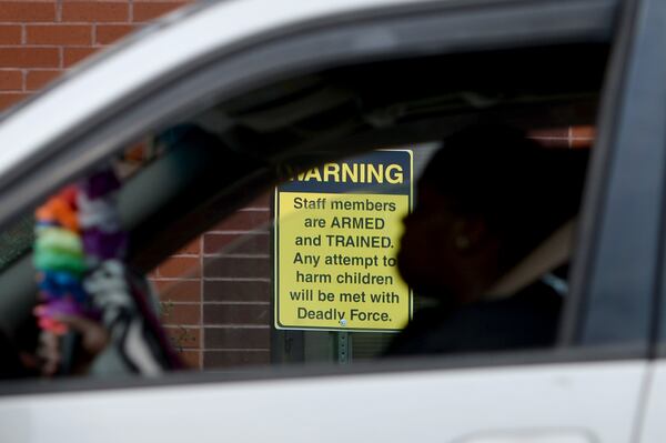 03/25/19 - Dublin -  Shamecca Plummer, a parent of students who attend East Laurens Middle-High School, waits on Monday in her car for her kids to get out of school. The school has posted signs to let visitors know staff members are carrying weapons. Plummer says she doesn't think firearms have any place in schools. "I don't think it's good because you never know. A kid might could still find a weapon and use it on the teacher or whoever," she says. "It's really dangerous to have it on campus anyway." Jenna Eason for The Atlanta-Journal Constitution.