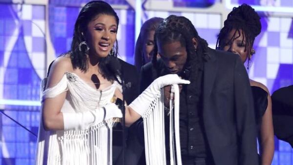 Cardi B, left, accepts the award for best rap album for "Invasion of Privacy" as Offset kisses her hand at the 61st annual Grammy Awards on Sunday, Feb. 10, 2019, in Los Angeles.