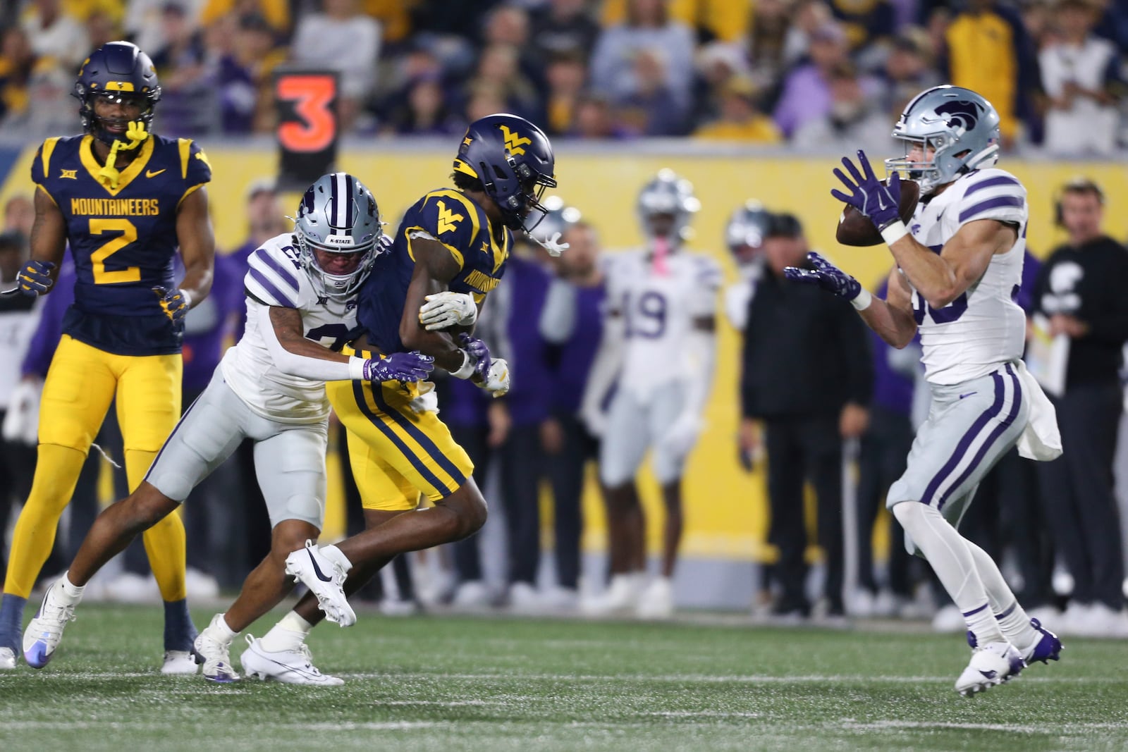 Kansas State safety Jack Fabris (36) intercepts the pass intended for West Virginia wide receiver Traylon Ray (7) during the frist half of an NCAA college football game, Saturday, Oct. 19, 2024, in Morgantown, W.Va. (AP Photo/William Wotring)