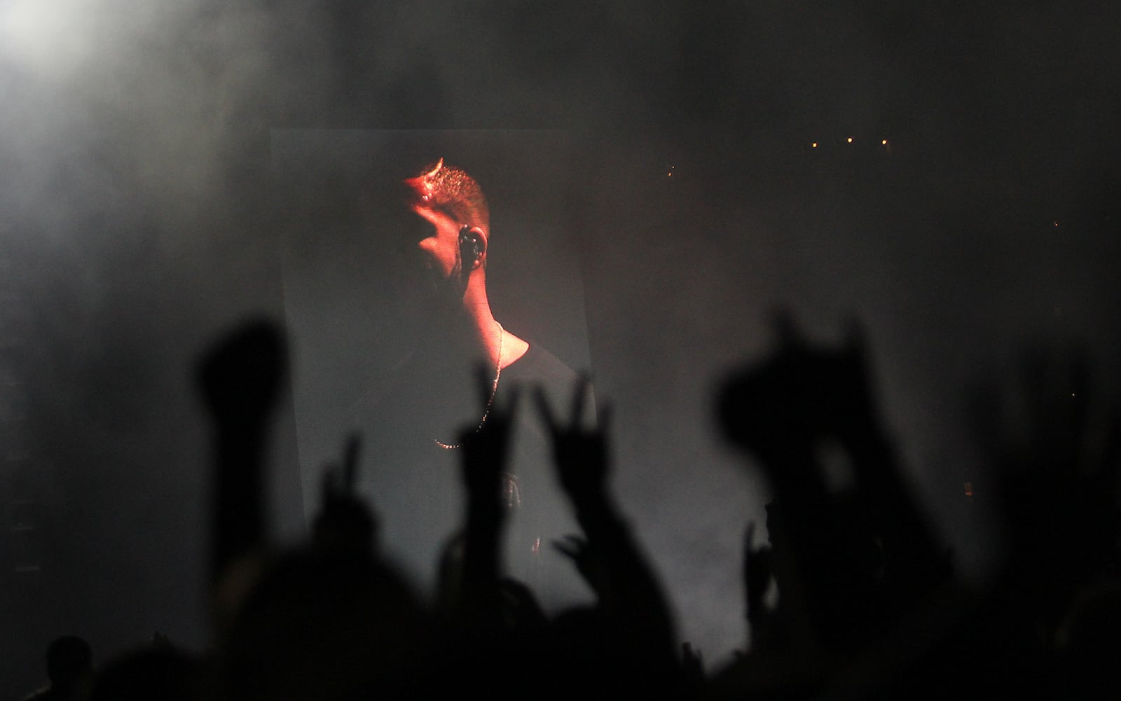 Silhouette of fans hands against the jumbo screen image of Drake during his performance at the Music Midtown on Friday, Sept. 18, 2015. (Akili-Casundria Ramsess/Special to the AJC)