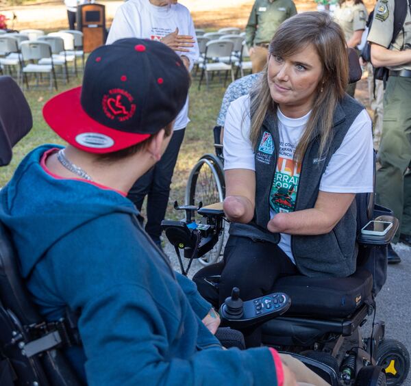 Aimee Copeland (right) spoke with Ben Oxley before a ceremony where All Terrain Georgia, an initiative of Aimee Copeland Foundation in partnership with Georgia Department of Natural Resources, introduces the all-terrain chairs they provide to enable the mobility impaired to get out in nature. One of the Action Trackchairs was available to try out at a Panola Mountain State Park after the ceremony. PHIL SKINNER FOR THE ATLANTA JOURNAL-CONSTITUTION