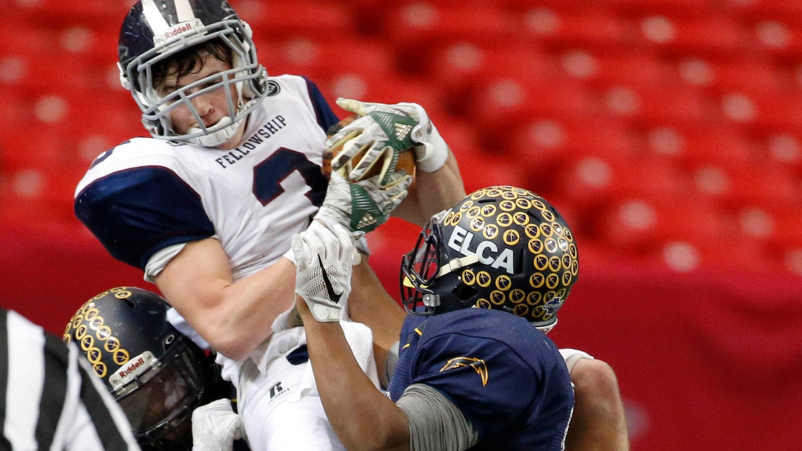 Fellowship wide receiver Ryan Reid (3) makes a leaping catch over ELCA defensive back Josh Mays (5) during the Class A-Private state championship game Friday, Dec. 9, 2016, at the Georgia Dome in Atlanta. (Jason Getz/Special to AJC)