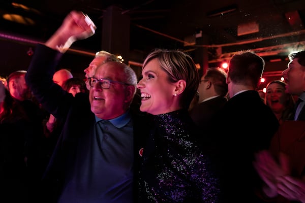 Kristrún Mjöll Frostadóttir, leader of the Samfylking, Social Democratic party, right, celebrates with a supporter at the celebration party following the closure of the polling stations in Reykjavik, Saturday Nov. 30, 2024. (AP Photo/Marco di Marco)