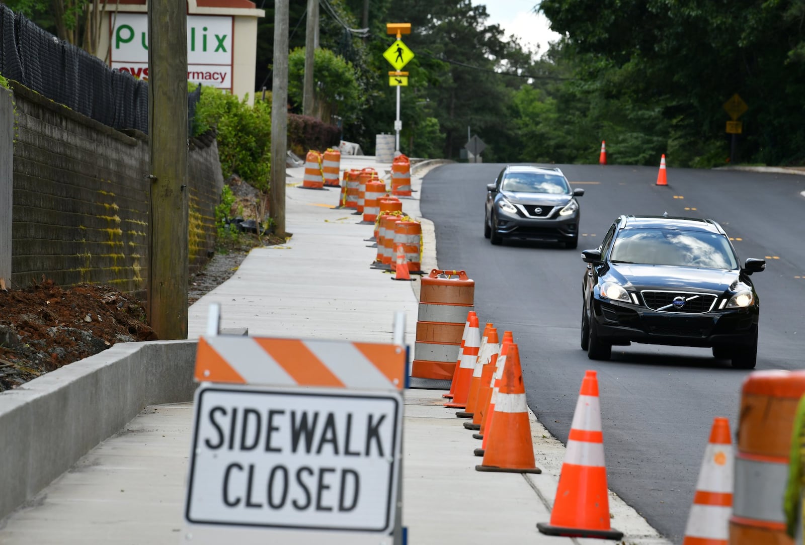 Construction of a new multi-use path along the eastern side of Ashford Dunwoody Road near the Publix on Tuesday, May 15, 2020. (Hyosub Shin / Hyosub.Shin@ajc.com)