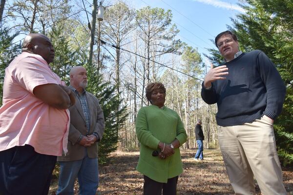 In March 2017, Mike Merideth (from left), Michael Bowen, Bobbie Hart and Wesley Edwards talk near the site where Austin Callaway, a black man who had been lynched, was found on a rural country road in 1940. Much work went into telling Callaway’s story on a historical marker. HYOSUB SHIN / HSHIN@AJC.COM