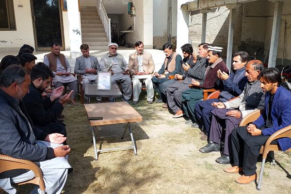 People offer prayer for local journalist Janan Hussain, who was killed in a gunmen firing incident, at his home, in Parachinar, main town of Kurram district of Pakistan's northwestern Khyber Pakhtunkhwa province, Friday, Nov. 22, 2024. (AP Photo/Hussain Ali)