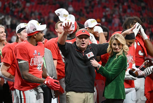 Georgia head coach Kirby Smart and players celebrate victory over Texas in overtime during the SEC Championship football game at the Mercedes-Benz Stadium, Saturday, December 7, 2024, in Atlanta. Georgia won 22-19 over Texas in overtime. (Hyosub Shin / AJC)