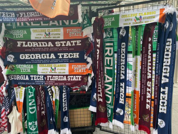 Georgia Tech and Florida State fans had many options for scarves at a kiosk in downtown Dublin prior to the Aug. 24, 2024 meeting between the two teams. (AJC photo by Ken Sugiura