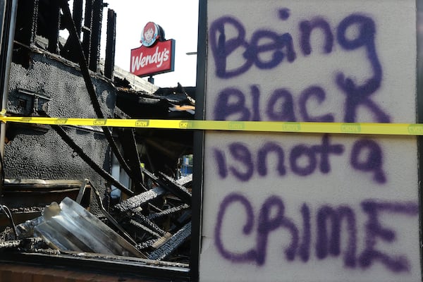 The charred ruins of the Wendy’s where Rayshard Brooks, a 27-year-old Black man, was shot and killed by Atlanta police on June 12, 2020, during a struggle in the drive-thru line. (Curtis Compton / ccompton@ajc.com)