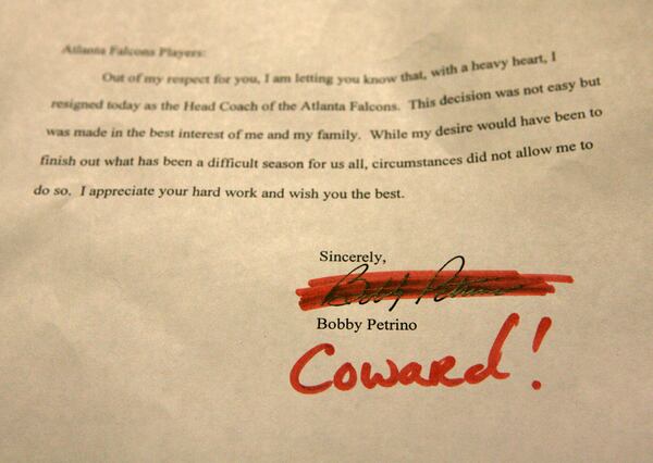 Falcons safety Lawyer Milloy scratched through Bobby Petrino's letter to the players and replaced his name with the word "Coward!" at the team facility in Flowery Branch.    CURTIS COMPTON / Staff