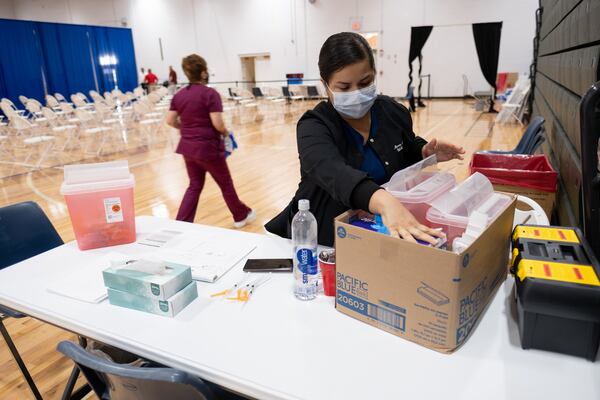 Maria Rivera packs up at the end of the last operating day of the mass vaccination site at the University of North Georgia's Gainesville campus on July 30. Only 11 people were vaccinated that day. (Ben Gray for the Atlanta Journal-Constitution)