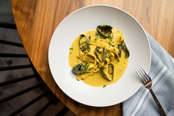 Tagliatelle Butternut Squash Curry with mussels, Calabrian chilis, and basil. Photo credit- Mia Yakel.