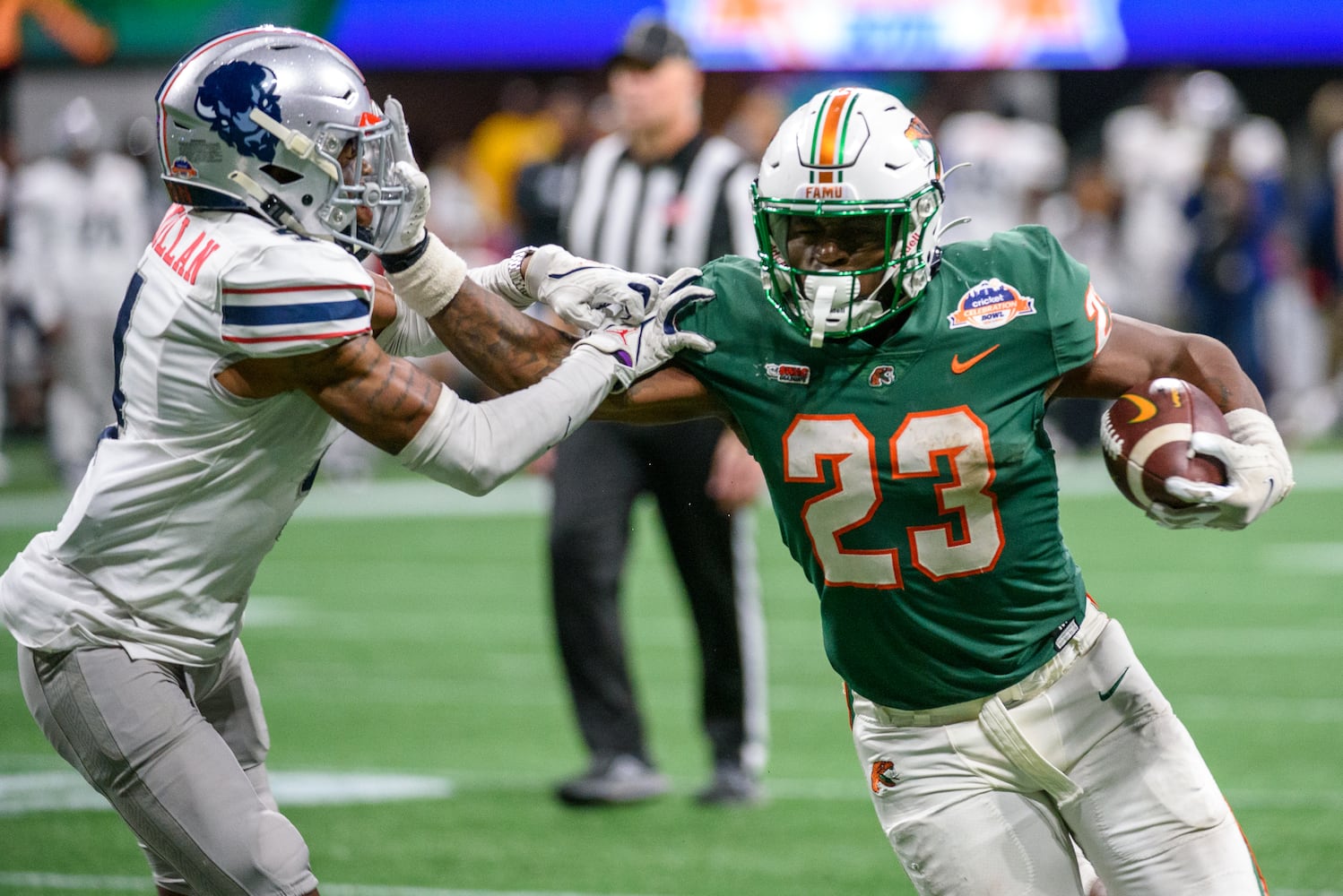 Florida A&M running back Terrell Jennings gets past Howard defensive back Lance McMillian during the Celebration Bowl at Mercedes Benz Stadium in Atlanta, Georgia on Dec. 16, 2023. (Jamie Spaar for the Atlanta Journal Constitution)