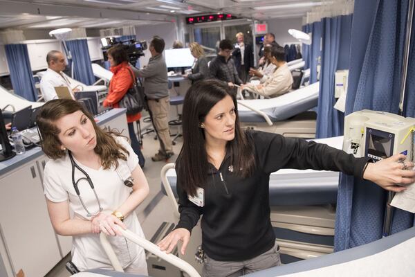 Nurse Kristy Haynes, right, shows resident nurse Brittany Evans around Carolinas MED-1, a mobile medical facility outside of the Marcus trauma and emergency room at Grady Memorial Hospital, on Monday, Jan. 29, 2018. ALYSSA POINTER/ALYSSA.POINTER@AJC.COM