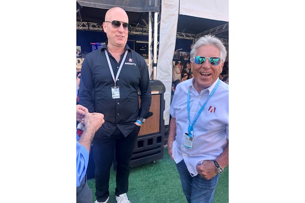 Dan Towriss, the new owner of Andretti Global, laughs with Mario Andretti before the IndyCar Series season-opening race, Sunday, March 2, 2025, in St. Petersburg, Fla. (AP Photo/Jenna Fryer)