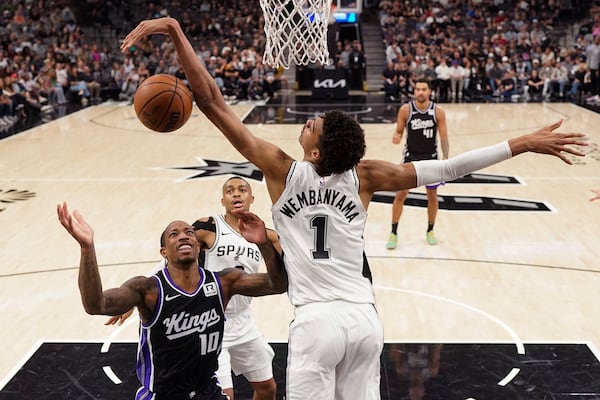 Sacramento Kings forward DeMar DeRozan (10) is blocked by San Antonio Spurs center Victor Wembanyama (1) during the first half of an NBA basketball game in San Antonio, Monday, Nov. 11, 2024. (AP Photo/Eric Gay)