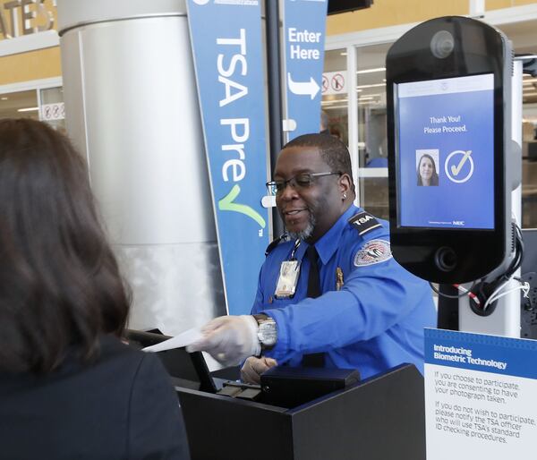 At the security check point, Transportation Security Administration agent Phillip Oree clears a passenger who used facial recognition for screening. BOB ANDRES / BANDRES@AJC.COM