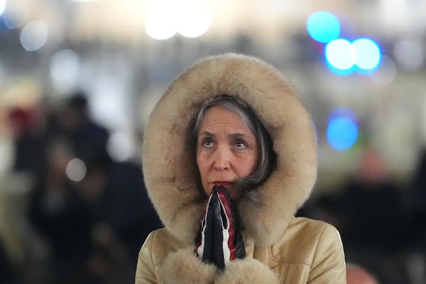 A woman attends a rosary prayer service with Cardinal Luis Antonio Tagle held for the health of Pope Francis in St Peter's Square at The Vatican, Tuesday, Feb. 25, 2025. (AP Photo/Kirsty Wigglesworth)