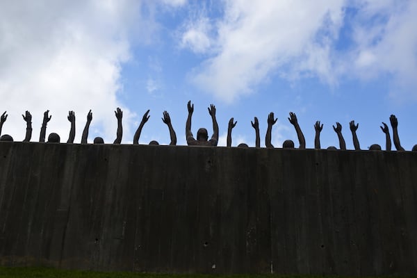 This photo shows a bronze statue called “Raise Up” as part of the display at the National Memorial for Peace and Justice. The new memorial to honor thousands of people killed in racist lynchings opened in April in Montgomery, Ala. AP PHOTO / BRYNN ANDERSON