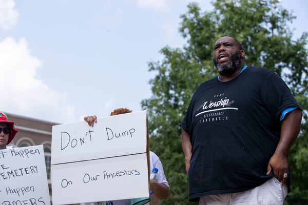 07/26/2021 — Newnan, Georgia —Pastor Render Godfrey, right, makes remarks outside of the Coweta County Historic Courthouse during a rally for the preservation of the Farmer Street Cemetery in Newnan, Monday, July 26, 2021. (Alyssa Pointer/Atlanta Journal-Constitution)