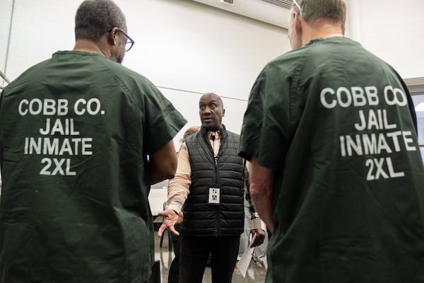 Michael Wilson, a case manager with the Get To Work Foundation, talks to inmates in the Cobb County Jail's honor dorm about services available to them upon release. The foundation provides three months of rent to veterans. Ben Gray for the AJC