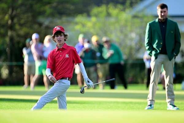 Trace Carter, who competed in the boys 14-15 division, reacts after a chip as Masters champion Bubba Watson watches during the Drive, Chip & Putt National Finals on April 3 at Augusta National Golf Club.