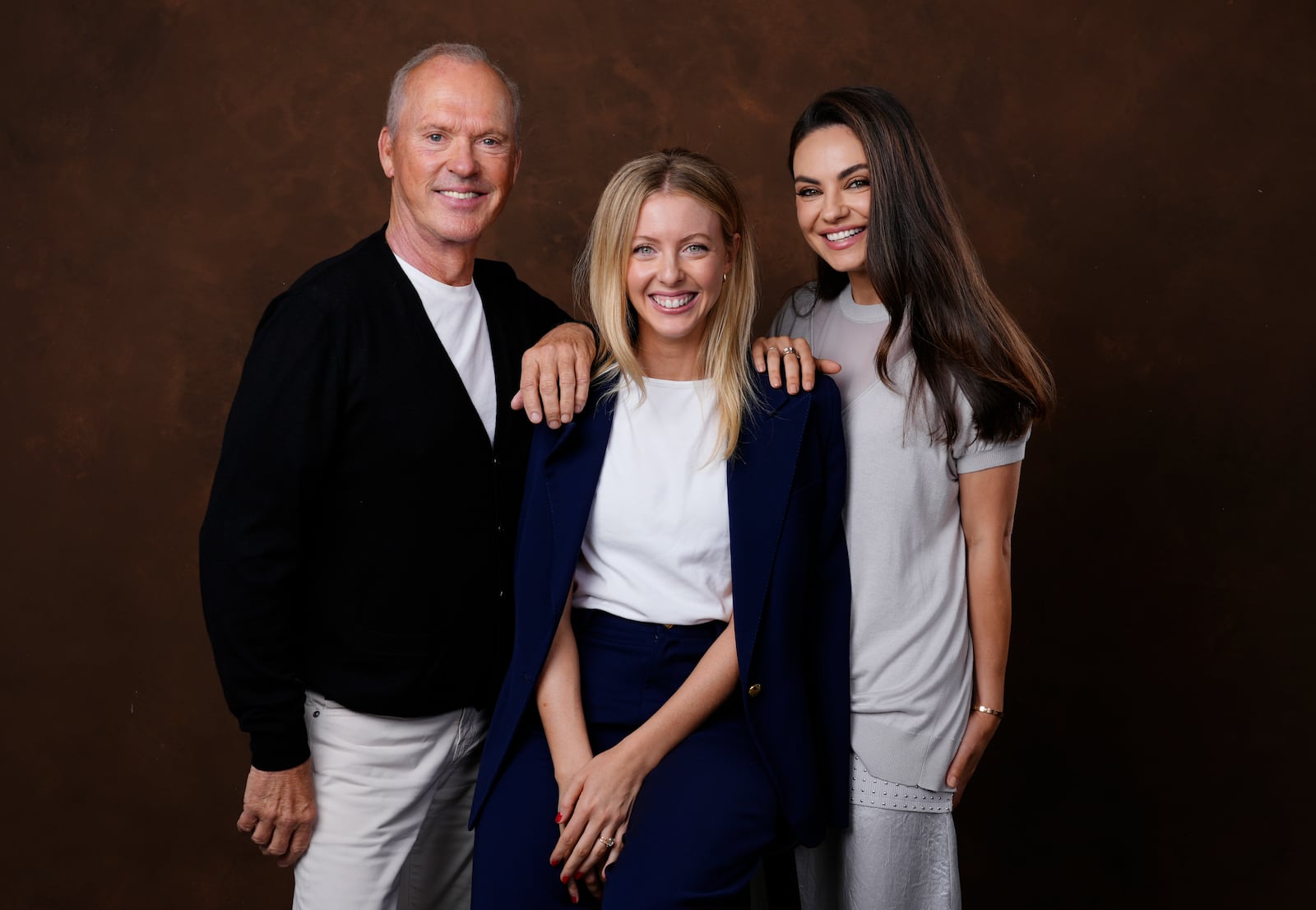 Hallie Meyers-Shyer, center, writer/director of "Goodrich," poses with cast members Michael Keaton, left, and Mila Kunis, Tuesday, Oct. 8, 2024, in Los Angeles. (AP Photo/Chris Pizzello)