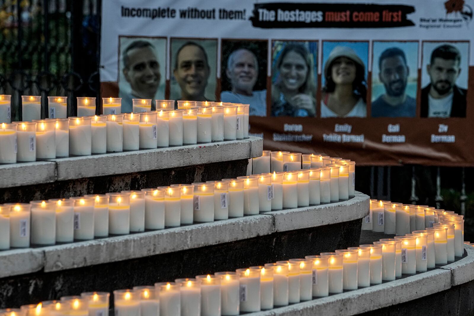 People light 1200 candles in front of the synagogue in Duesseldorf, Germany, Monday, Oct. 7, 2024, marking the first anniversary of the Oct. 7, 2023 attacks on Israel. (AP Photo/Martin Meissner)