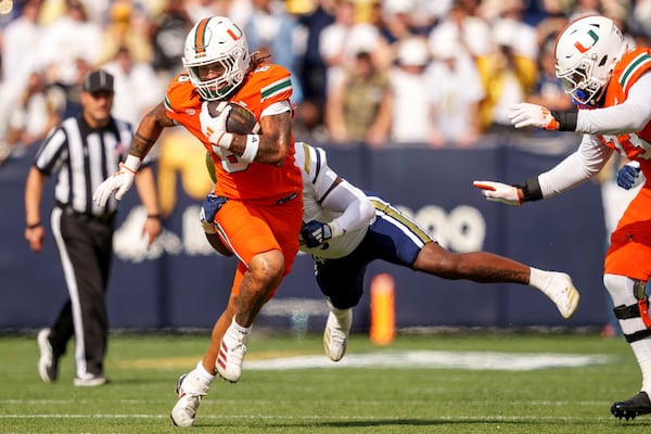 Miami running back Damien Martinez (6) runs the ball during the first half of an NCAA college football game against Georgia Tech, Saturday, Nov. 9, 2024, in Atlanta. (AP Photo/Jason Allen)