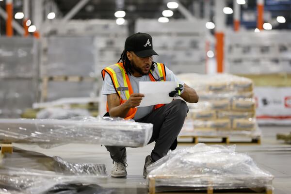 General warehouse associate Chad Witcher checks the order of the material he is taking to a flatbed truck for distribution. The massive new Home Depot warehouse in Stonecrest has more than two hundred employees distributed in three-shifts that work twenty hours a day. Monday, May 23, 2022. Miguel Martinez / miguel.martinezjimenez@ajc.com