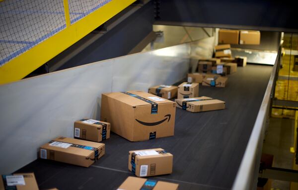 Boxes travel on conveyor belts at an Amazon Fulfillment Center. Amazon customers can download a report that lists how much they have spent on the  online retailer's site.