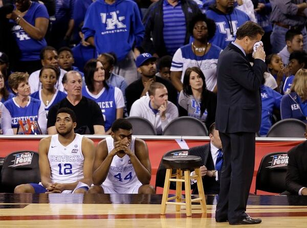 Kentucky head coach John Calipari wipes his face after the NCAA Final Four tournament college basketball semifinal game against Wisconsin Saturday, April 4, 2015, in Indianapolis. Wisconsin won 71-64.(AP Photo/Darron Cummings) Unbeaten no longer. (AP photo/Darron Cummings)