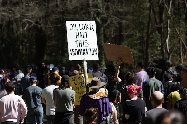 Chad Hale (Center) holds a sign during a protest to stop the development of the Atlanta Police Training Center, at Gresham park in Atlanta Saturday, March 4, 2023. (Steve Schaefer/steve.schaefer@ajc.com)