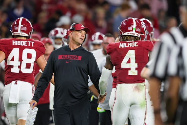 Alabama head coach Kalen DeBoer talks with Alabama quarterback Jalen Milroe (4) during the second half against Georgia at Bryant-Denny Stadium, Saturday, Sept. 28, 2024, in Tuscaloosa, Al. Alabama won 41-34. (Jason Getz / AJC)

