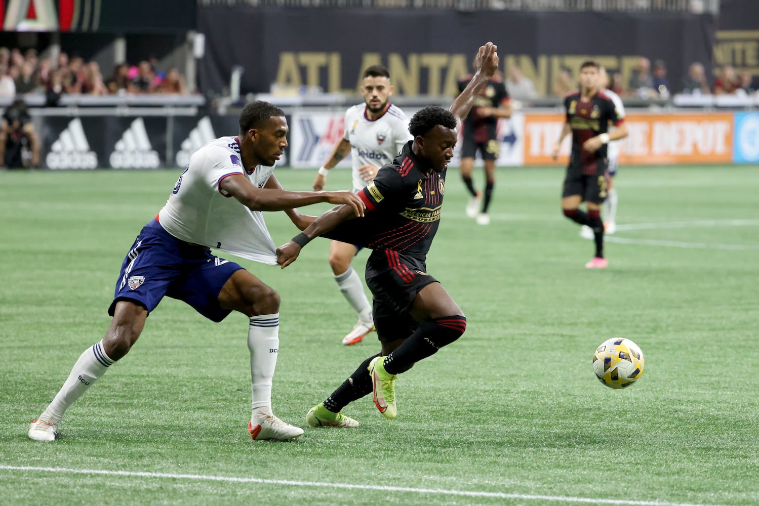 D.C. United defender Donovan Pines (23, left) fouls Atlanta United defender George Bellow (21) during the first half at Mercedes-Benz Stadium Saturday, September 18, 2021 in Atlanta, Ga.. JASON GETZ FOR THE ATLANTA JOURNAL-CONSTITUTION