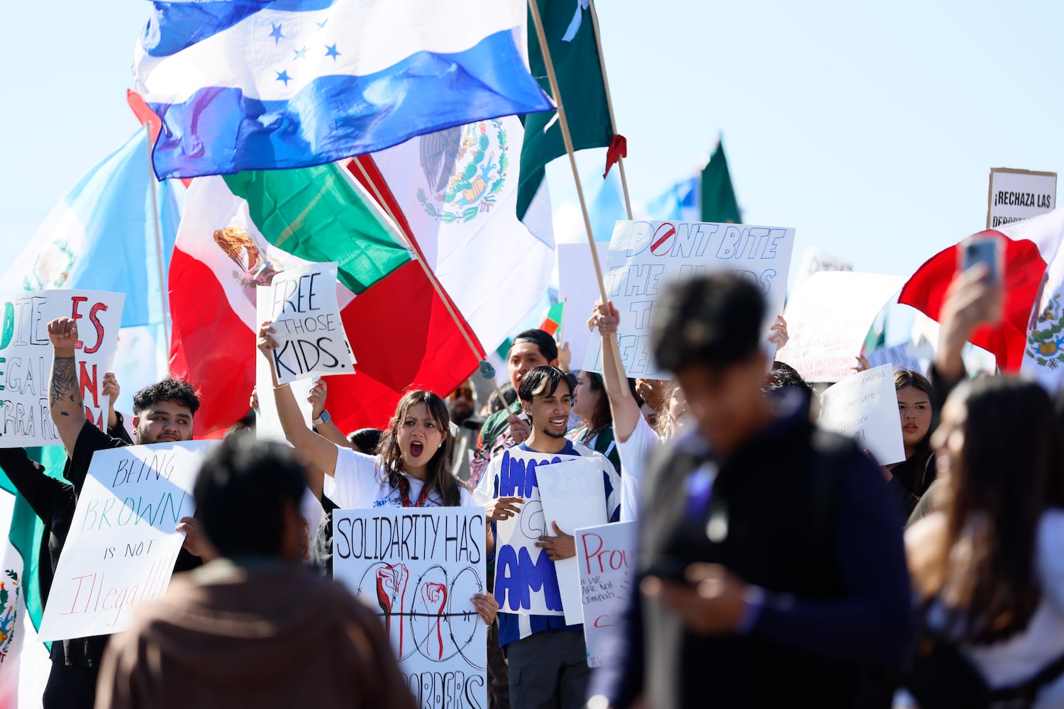 Pro-immigrant protesters chant on Buford Highway as they waved Latin-American flags near Plaza Fiesta on Saturday, Feb. 1, 2025, to demonstrate in response to a recent immigration arrest in Georgia. 
(Miguel Martinez/ AJC)