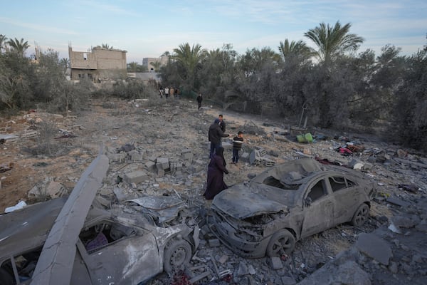 Palestinians inspect the site of an Israeli strike in Deir Al-Balah in the central Gaza Strip, Wednesday, Jan. 15, 2025. (AP Photo/Abdel Kareem Hana)