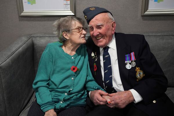 Michael Woods, 100-year-old World War II veteran, chats with his wife Mary during an interview in Dunstable, Bedfordshire, England, Tuesday, Nov. 5, 2024. (AP Photo/Kin Cheung)