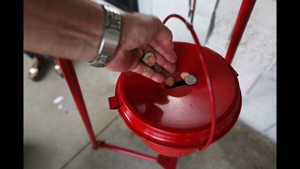 A donation is made into a Salvation Army red kettle on November 28, 2017 in Hallandale, Florida. Giving Tuesday is a single day following the heavy Thanksgiving shopping period specifically focused on charity. (Photo by Joe Raedle/Getty Images)