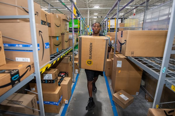 Damion Flowers, an Amazon sorting associate moves a package at an Amazon delivery station in Duluth on Tuesday, July 16, 2024.  (Ziyu Julian Zhu / AJC)