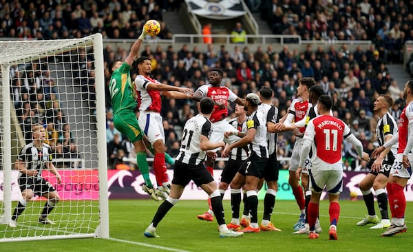 Newcastle United's goalkeeper Nick Pope clears the ball from a corner, during the English Premier League soccer match between Newcastle United and Arsenal, at St James' Park, in Newcastle, Saturday, Nov. 2, 2024. (Owen Humphreys/PA via AP)