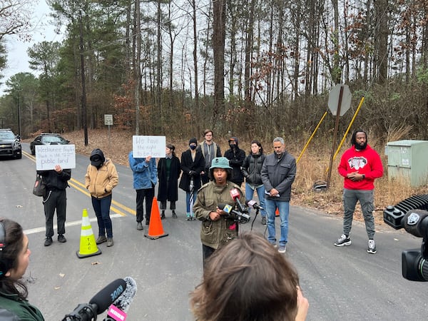 Activist Jasmine Burnett, of Community Movement Builders, speaks to the media Wednesday, Dec. 14, shortly after the announcement that the GBI had charged five protesters of Atlanta's new public safety training center with domestic terrorism.