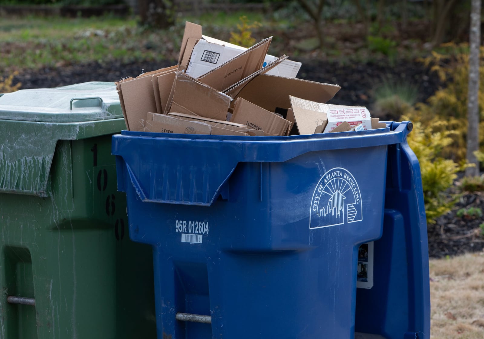 A city of Atlanta recycling bin full of cardboard awaits pickup in Ormewood Park on March 7, 2019. Despite efforts to educate consumers, some confusion about recycling exists. Not everything with the Mobius Loop (the three looping arrows) is recycled. Residents should consult their local jurisdiction to confirm what they can and cannot recycle. CONTRIBUTED BY PHIL SKINNER