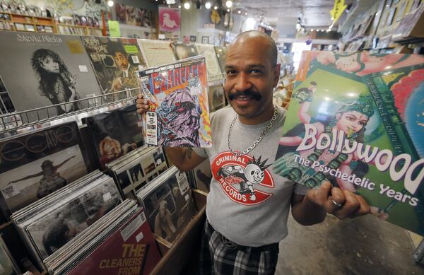 Caesar Ramirez shows some of the exclusive limited edition LPs that will be put out for Record Store Day. Local independent record store Criminal Records, located in Little Five Points, is one of more than 20 metro Atlanta businesses that will participate in the 10th annual Record Store Day on April 22. The event includes exclusive Record Store Day releases, raffles, live music and giveaways. BOB ANDRES / BANDRES@AJC.COM