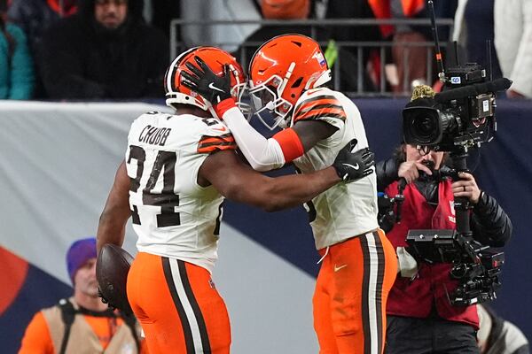 Cleveland Browns running back Nick Chubb (24) celebrates his 5-yard reception for a touchdown with wide receiver Jerry Jeudy during the second half of an NFL football game against the Denver Broncos, Monday, Dec. 2, 2024, in Denver. (AP Photo/David Zalubowski)