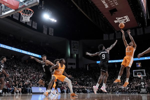 Tennessee guard Chaz Lanier (2) makes a basket over Texas A&M forward Solomon Washington (9) during the second half of an NCAA college basketball game Saturday, Feb. 22, 2025, in College Station, Texas. (AP Photo/Sam Craft)