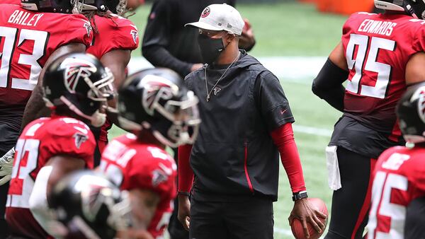 102520 Atlanta: Atlanta Falcons head coach Raheem Morris (center) greets players as they take the field ahead of matchup Sunday, Oct. 25, 2020, against the Detroit Lions at Mercedes-Benz Stadium in Atlanta. (Curtis Compton / Curtis.Compton@ajc.com)