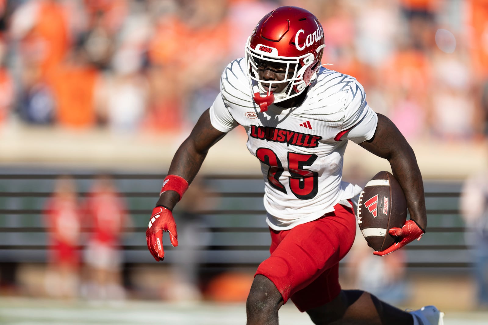 FILE - Louisville running back Isaac Brown (25) drives with the ball against Virginia during the first half of an NCAA college football game, Oct. 12, 2024, in Charlottesville, Va. (AP Photo/Mike Kropf, File)