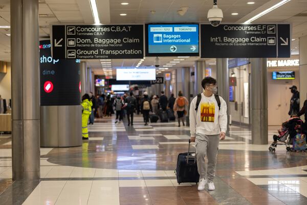 Travelers are seen moving through Hartsfield Jackson International Airport in Atlanta, Georgia on January 16, 2022. as a winter storm impacts travel. (Photo: Nathan Posner for The Atlanta Journal-Constitution)